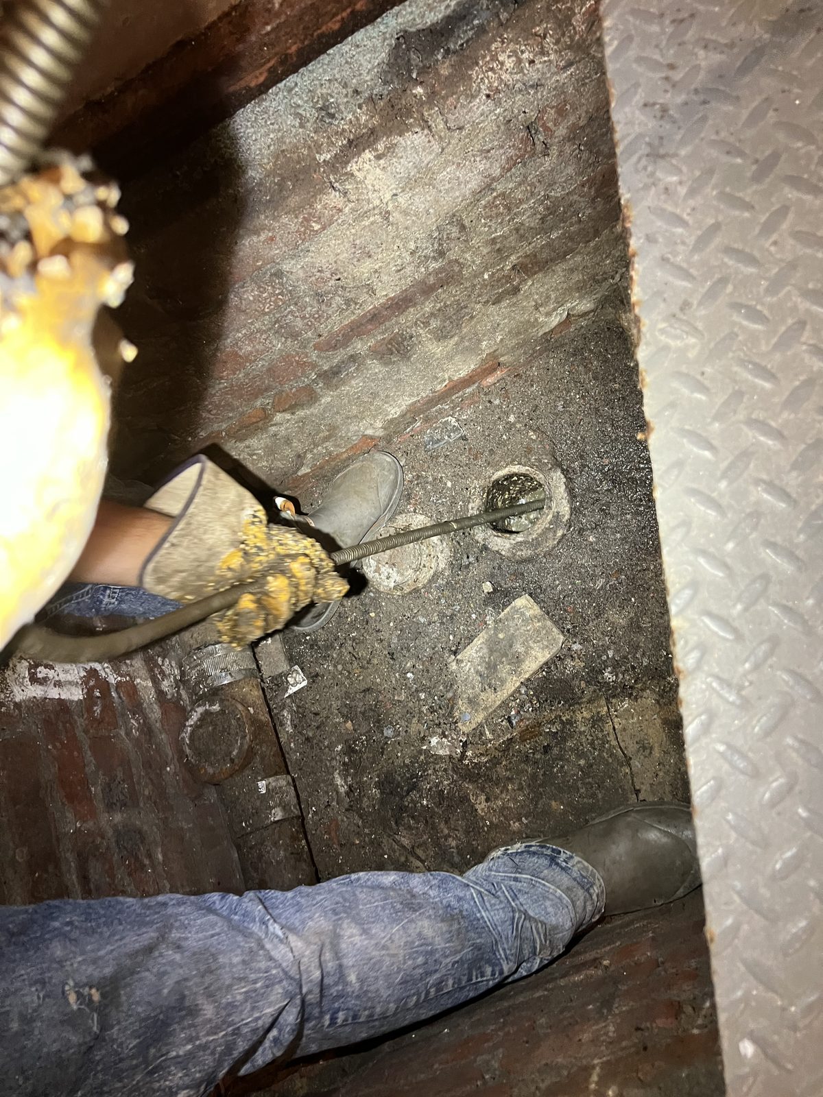 Cellar floor sewer cleanout at the base of a soil stack.