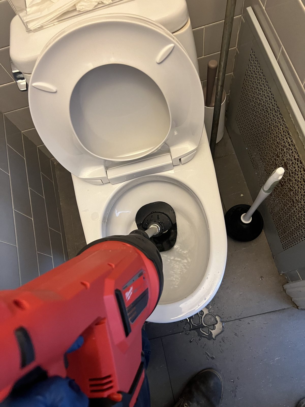 Closet auger clearing a blocked toilet in New York City.