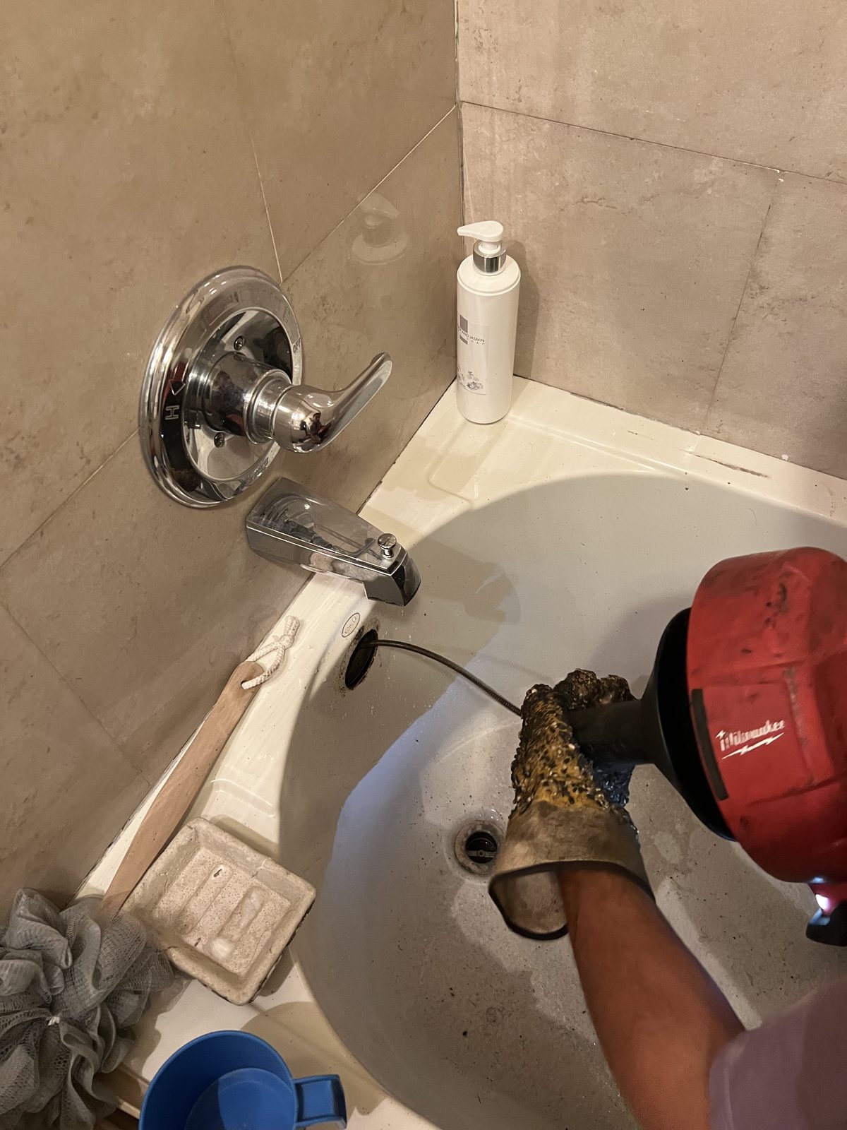 Snaking a clogged bathtub drain in a New York apartment.